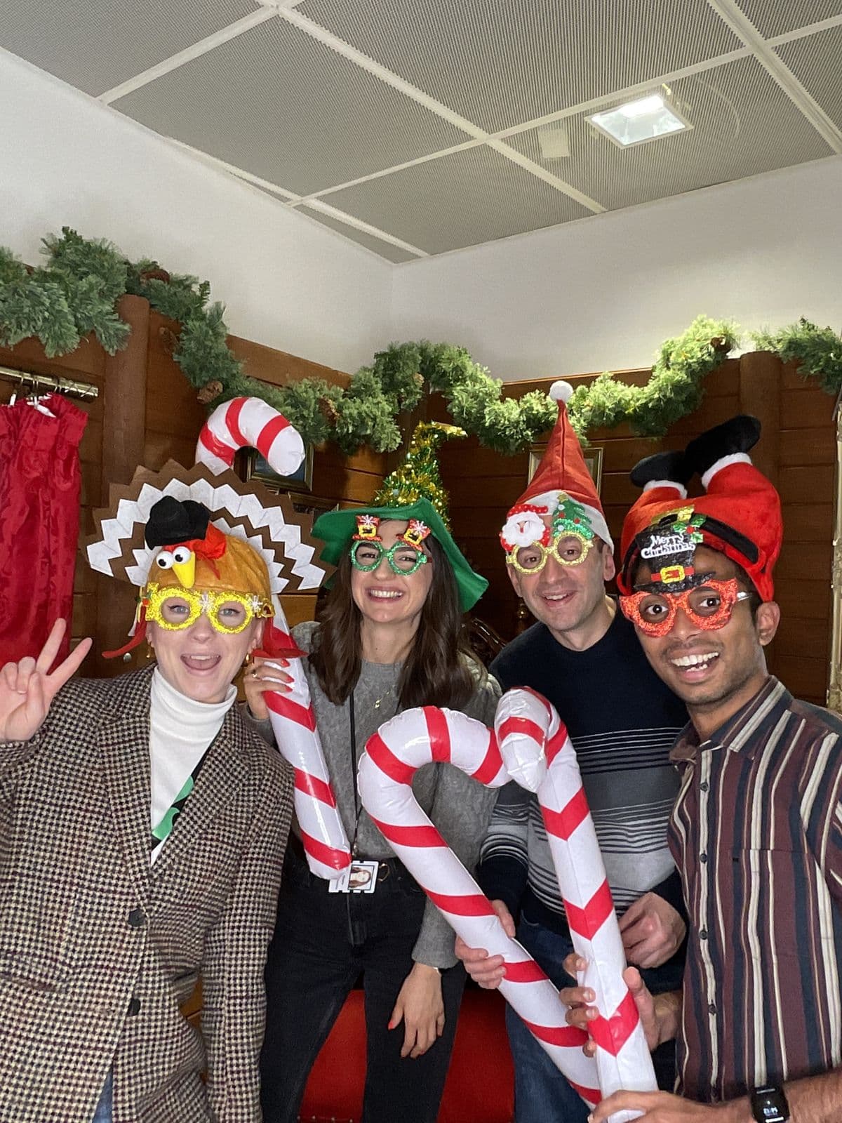 The team with inflatable candy canes at the Christmas photo booth
